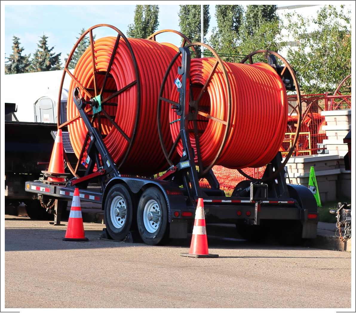 Large orange cable spools on trailer